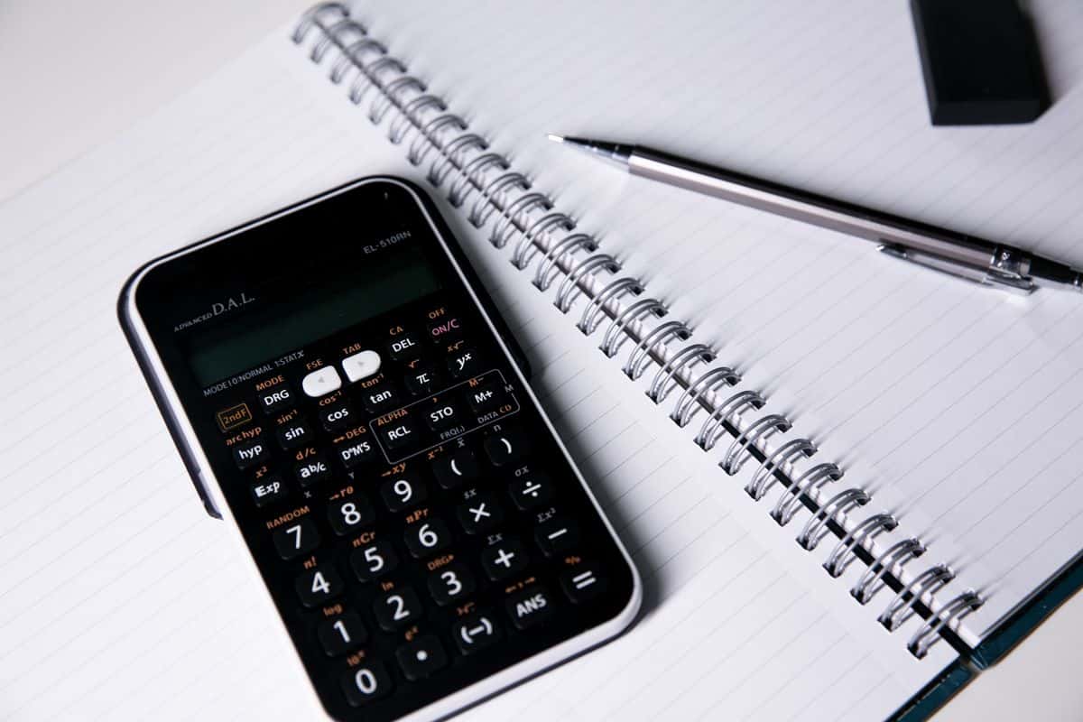 Calculator, notebook and pen for keeping financial records